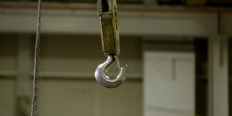 A hook hangs in a warehouse
