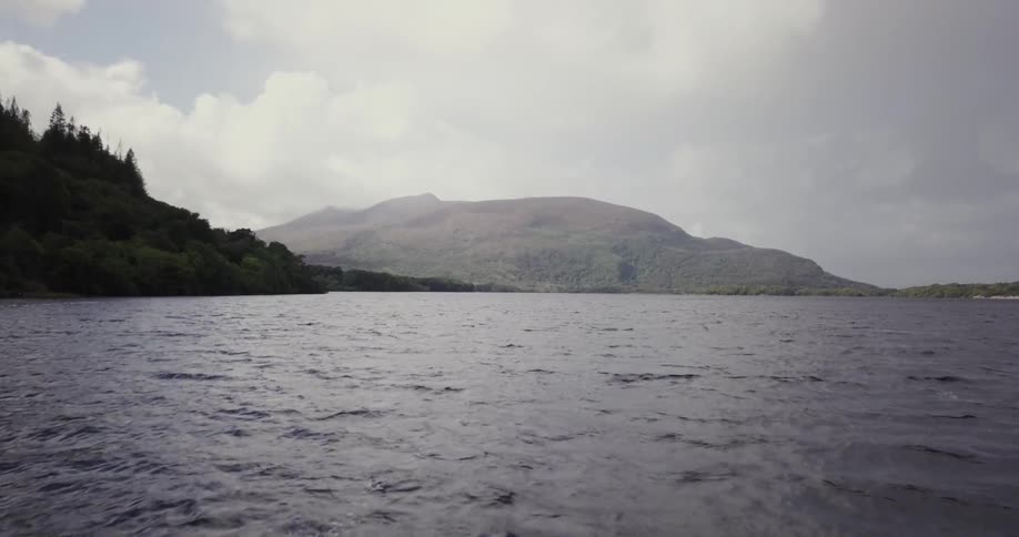 Looking down at a large body of water then looking up towards the mountain in the distance