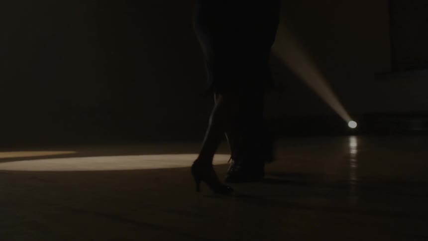 A couple slowly dance in the dark