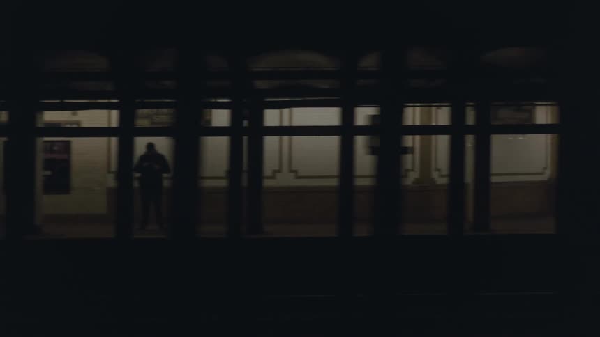 A train drives through a subway station