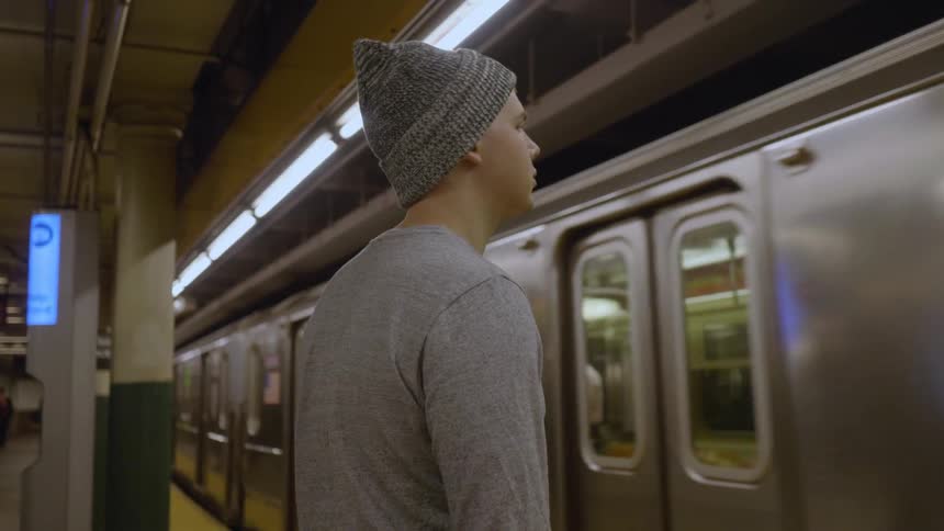 A man waits for a subway train