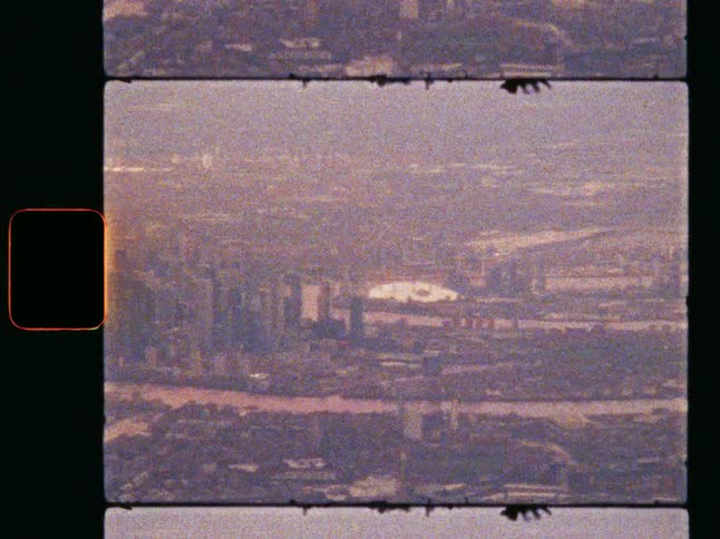 Vintage super 8 film captures the hazy London skyline, including Canary Wharf, the River Thames and the O2 Arena