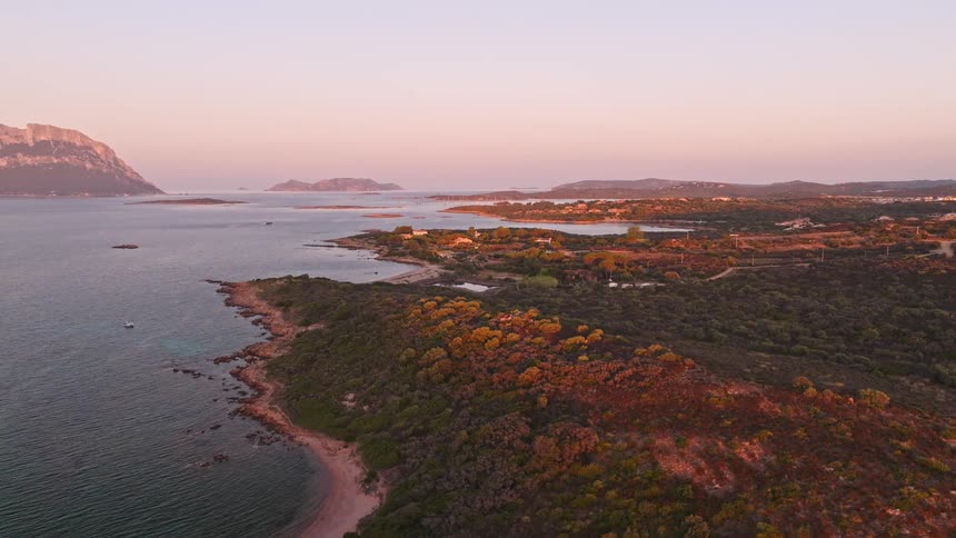 Aerial view of a stunning Sardinian coastline at sunrise with the Tavolara island in the background