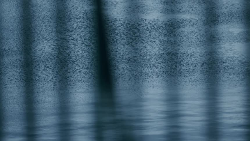A moody, abstract background featuring a textured blue surface with dark vertical shadows reflected in rippling water