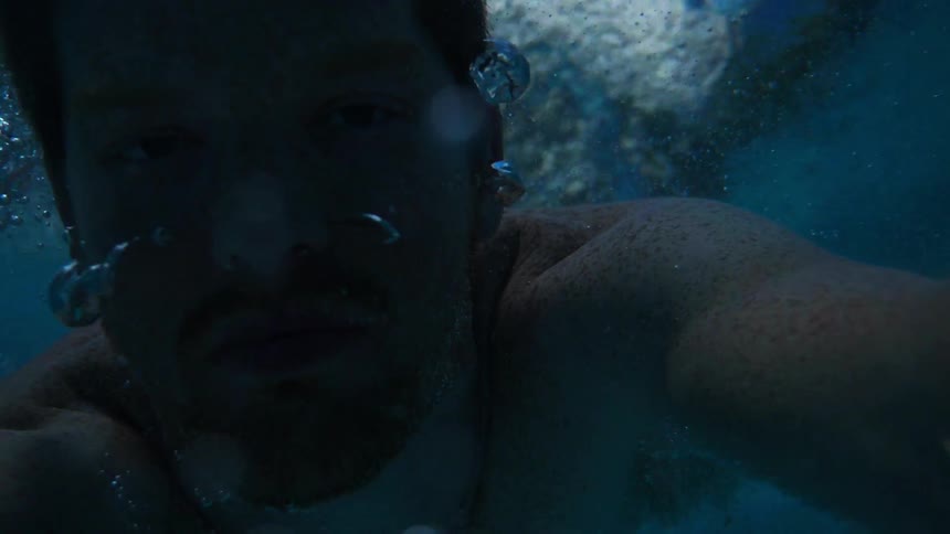 A man swims underwater