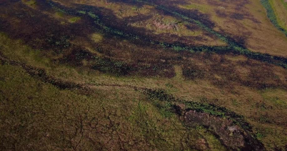 The green pastures below have some rocks lining the hills