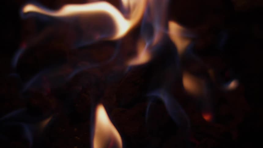 A fire burns at night