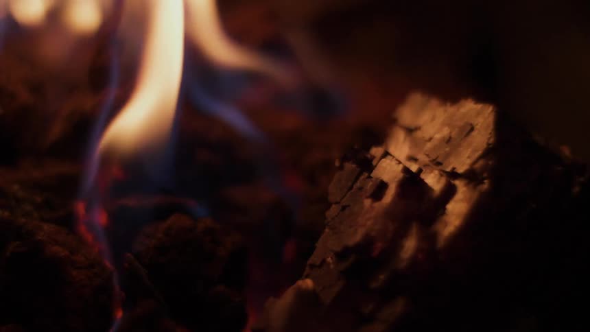 A small fire burns at night