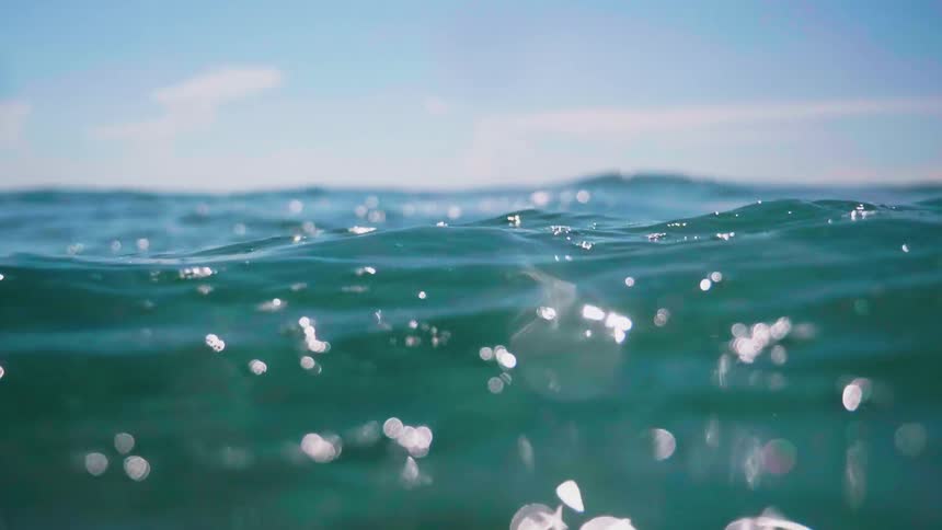 Waves move under the bright sun