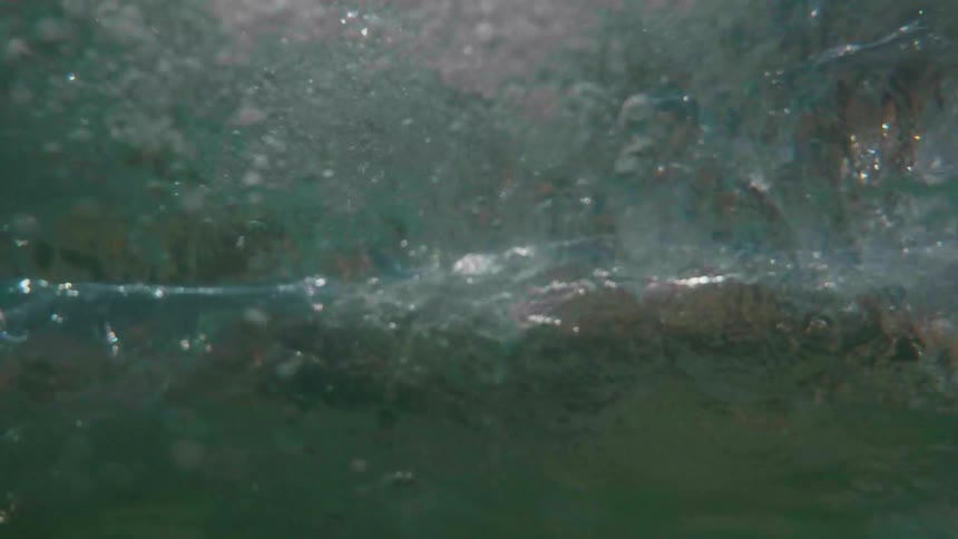 Ocean waves are rolling and tumbling under water