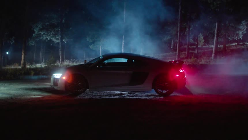 A car sitting on a road with its lights on and no one inside
