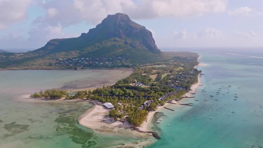 A stunning static aerial view of the Le Morne Brabant peninsula in Mauritius, with its iconic mountain, turquoise lagoon, and luxury resorts