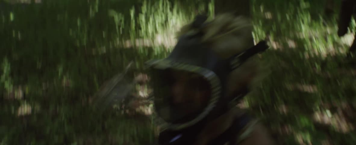 A person with a mask on running through the woods