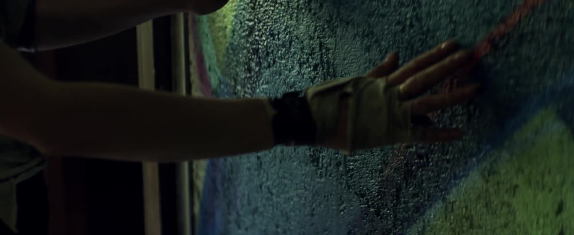 Woman slams hand and leans her head against a wall