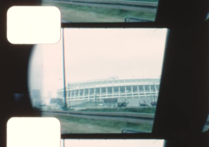 A vintage 8mm film montage of various landmarks in and around Atlanta, Georgia, including the Federal Reserve, a prison, and the city skyline