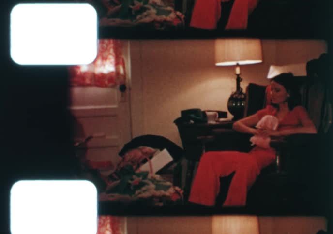 A nostalgic 1970s home movie captures a family celebrating Christmas morning with children and their new toys