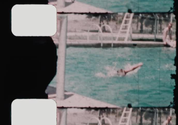 Two boys swim in an outdoor pool, with a close-up on one smiling at the camera, captured on vintage 8mm film