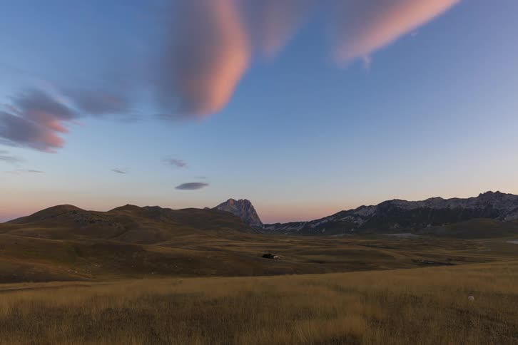 A glorious sunrise timelapse reveals golden light sweeping across a vast mountain valley