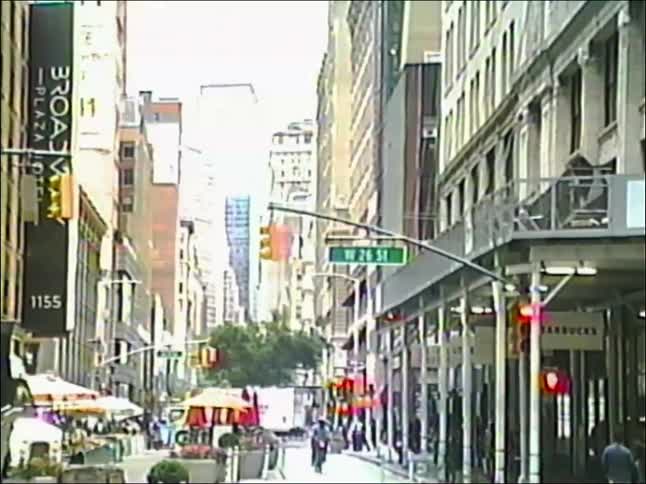 Authentic VHS footage of a busy street corner in New York City with traffic and pedestrians