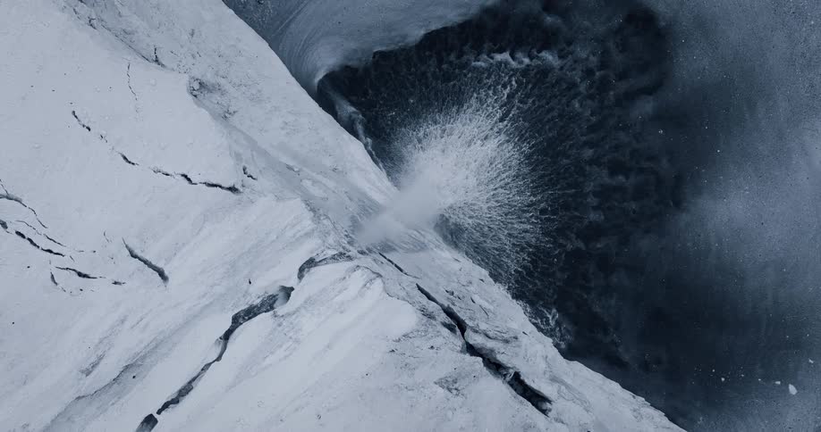 A seamless, top-down animated loop of a powerful waterfall cascading from a cracked white cliff into dark, mysterious water