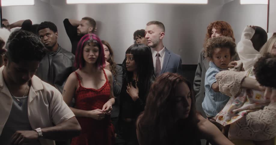 Anxious and impatient people from diverse backgrounds wait uncomfortably in a crowded, slow-moving elevator