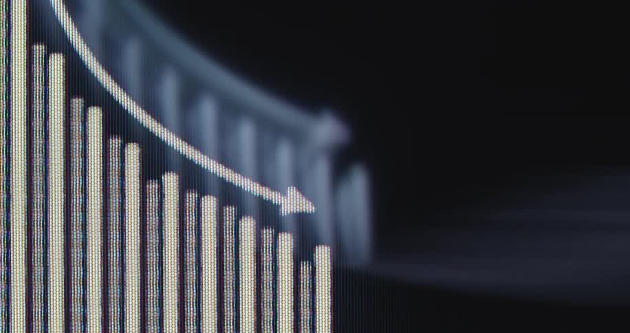 A macro shot of a digital screen shows a bar graph and arrow trending downward, symbolizing an economic crisis or stock market decline