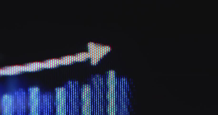 An extreme close-up of a digital stock market graph shows a positive upward trend with a rising arrow and bar chart on a pixelated screen