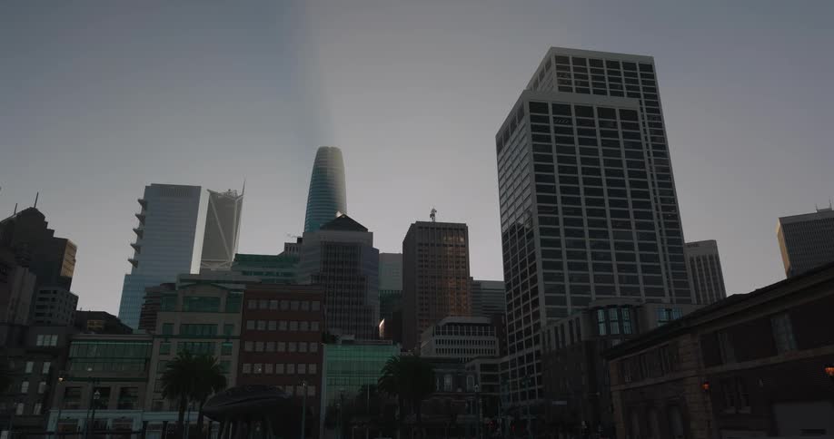 A static shot captures the downtown San Francisco skyline, including the Salesforce Tower, under a clear sky at dusk