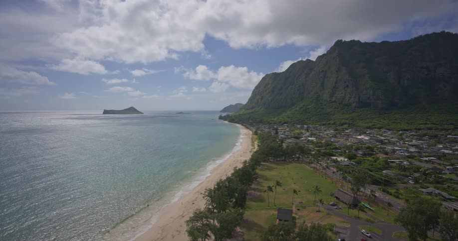 A stunning aerial view flying over the lush tropical coastline of Waimanalo Beach in Oahu, Hawaii