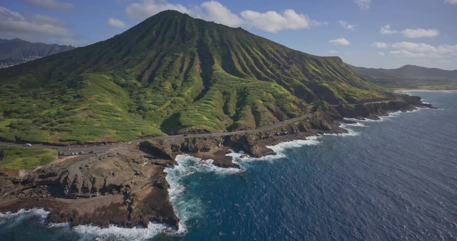 A wide, static aerial shot captures the scenic Koko Head crater alongside the rugged volcanic coastline and the deep blue Pacific Ocean on the island of Oahu, Hawaii