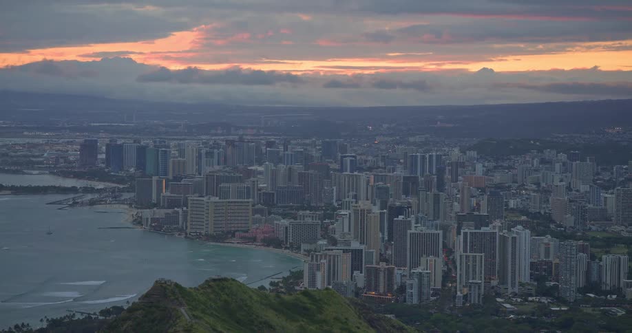 An epic sunrise view from the peak of Diamond Head reveals the beautiful cityscape of Honolulu, Hawaii