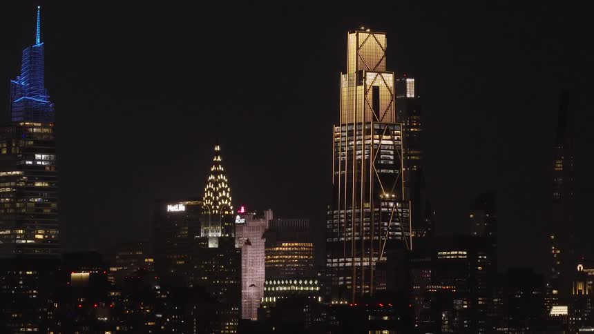 A stunning timelapse of the iconic New York City skyline at night, featuring brightly illuminated skyscrapers against the dark sky