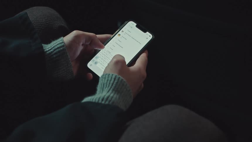 A person holds a smartphone, browsing through various online shopping and messaging applications