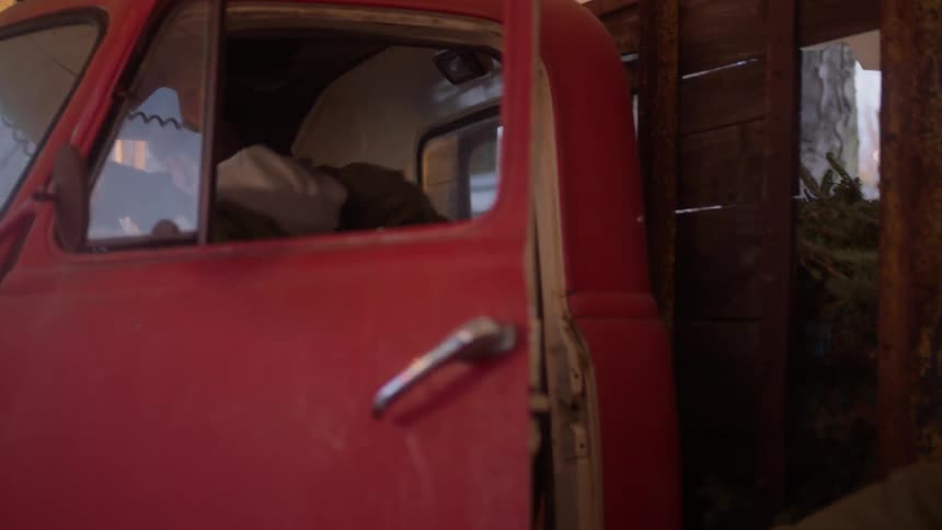 A man walks with a boy over to a truck