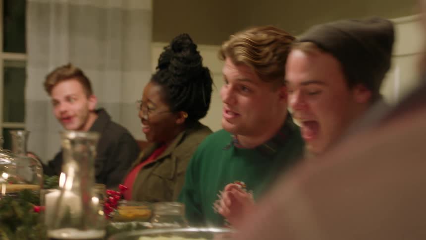 Group of people sitting around a table talking