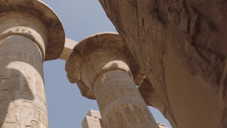 A slow dolly backwards reveals the immense scale of the ancient Egyptian temple columns at Karnak