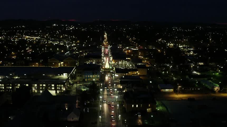 Cars drive on a city street at night