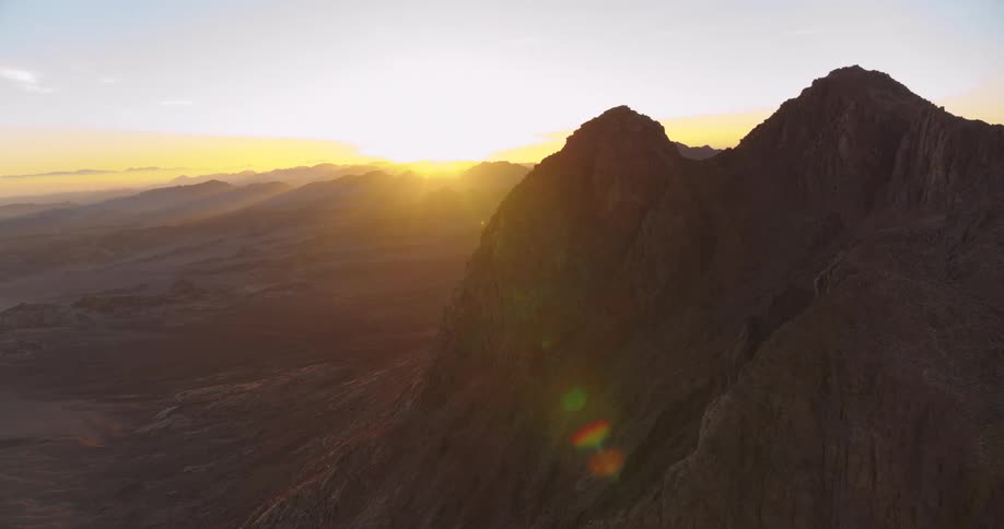 An awe-inspiring aerial view captures the sunrise over the majestic peaks of Mount Sinai in Egypt