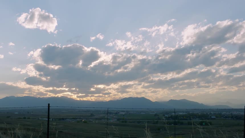 Clouds float over a rural area at sunset