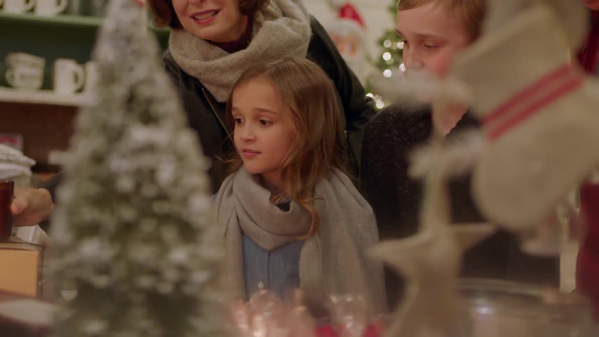 A child is looking at toys as others browse