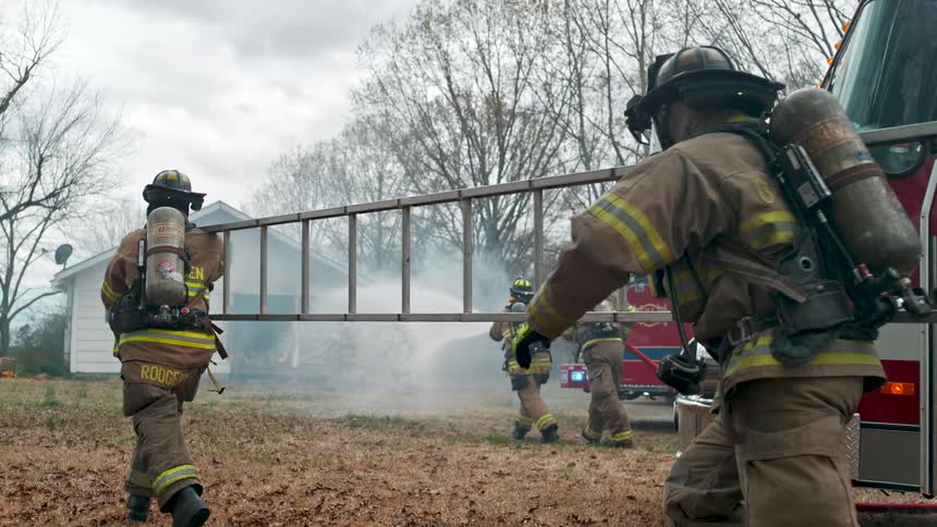 Firefighters in full gear respond to a house fire, running with hoses and ladders to extinguish the flames