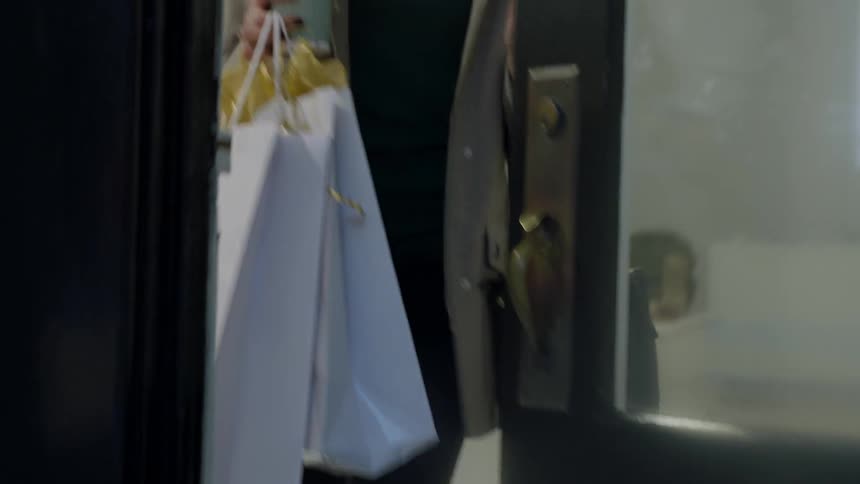 Woman carrying a shopping bag leaves a store