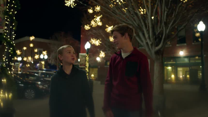Two boys play around laughing at night
