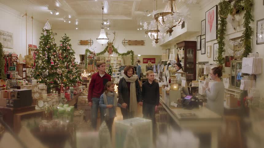 A family wanders around a christmas store