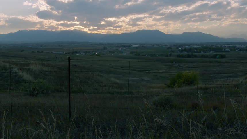 Clouds float over a rural area at sunset