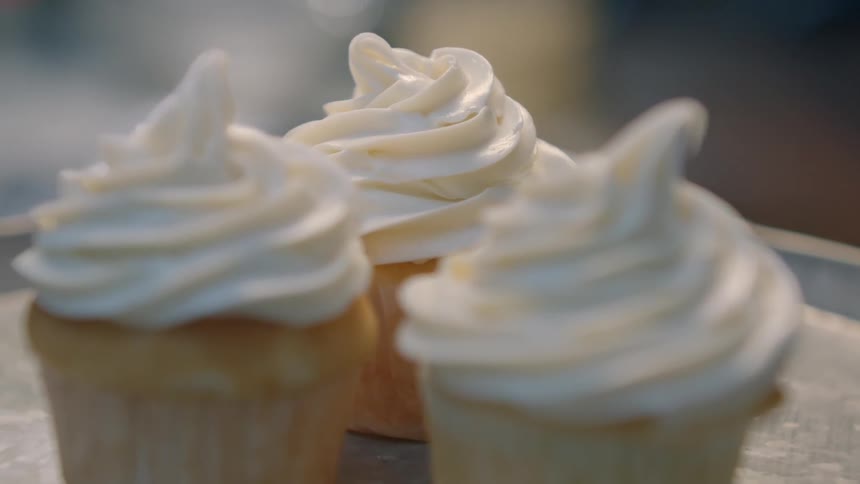Vanilla cupcakes with white frosting on top