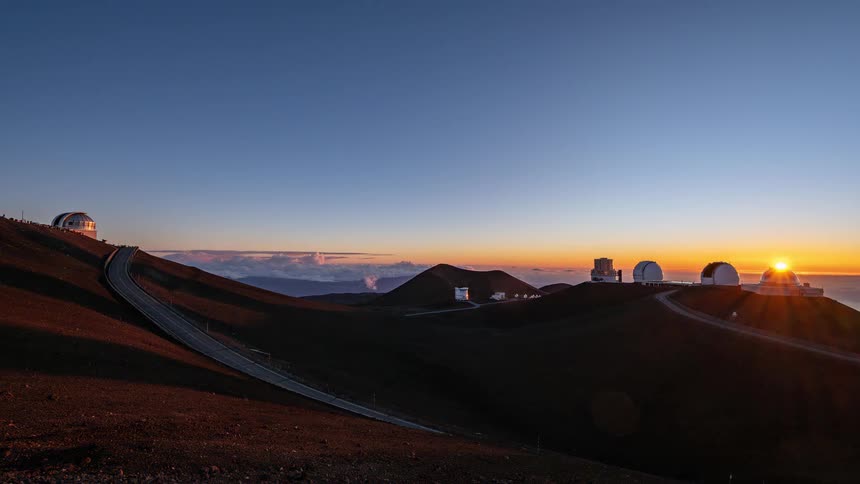 A stunning day-to-night timelapse of the sun setting over the Mauna Kea observatories atop a volcanic mountain in Hawaii