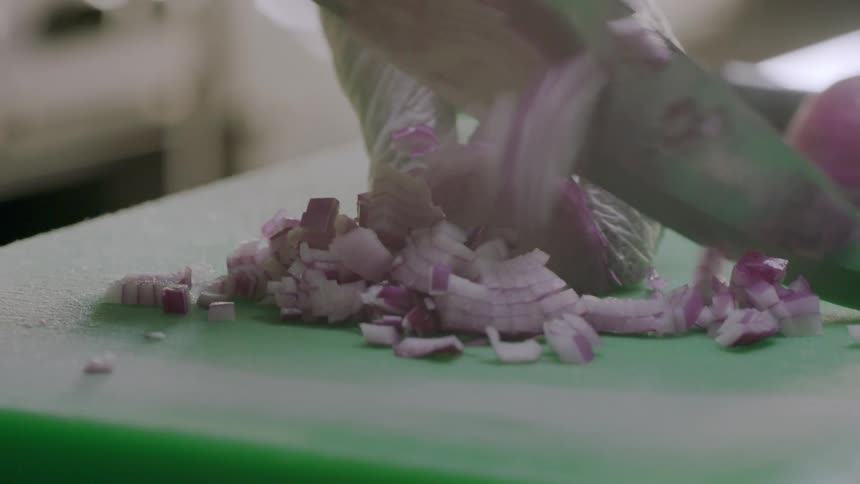 A person is cutting onions