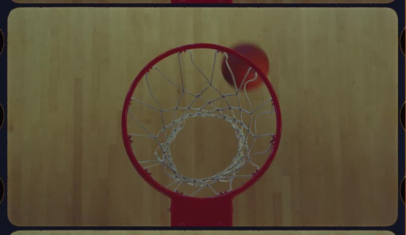 A vintage film-style overhead shot shows a basketball player making shots and practicing moves on an indoor court