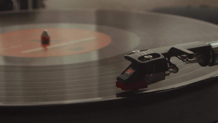 Close-up of a stylus gliding across a spinning vinyl record on a vintage turntable